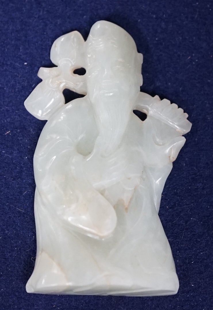 A Chinese pale celadon jade figure of Shou Lao, wood stand, 10cm high